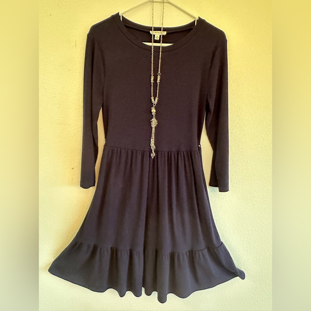 Navy 3/4 sleeve dress. Center back is 34”. Gathered skirt with attached ruffle.